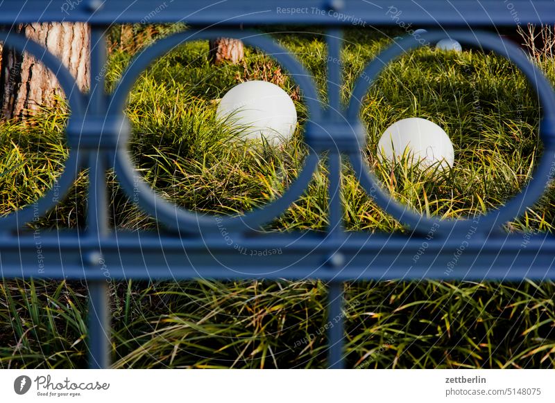 Two ball lamps behind fence Berlin Dahlem Relaxation Recreation area Green Park To go for a walk trunk surrounding area Fence Metalware Iron wrought-iron Sphere