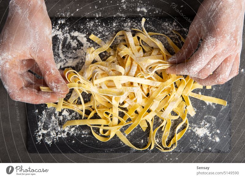 Italian pasta cooking process. Fresh food concept. Home made tagliatelle fresh flour kitchen meal cuisine home homemade raw preparation healthy traditional chef