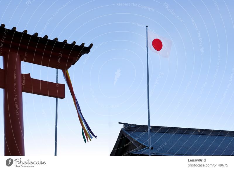 Japanese flag next to a Torii in Kumano Nachi Taisha Shrine near