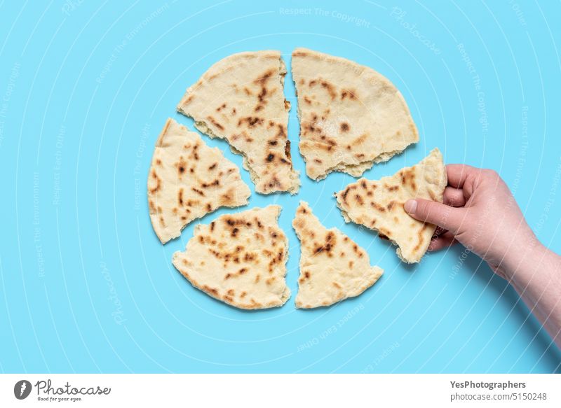 Indian flat bread above view. Woman taking a piece of naan bread afghan arabic asian background baked bakery balkan blue classic color cuisine delicious eating