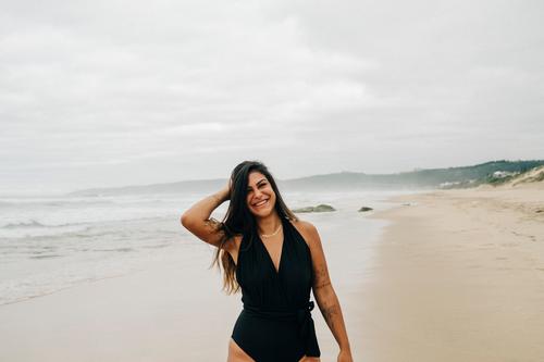 Laughing woman in black swimsuit on beach Woman Beach Swimsuit Laughter Joy Good mood omitted Happiness Joie de vivre (Vitality) Ocean Positive Human being