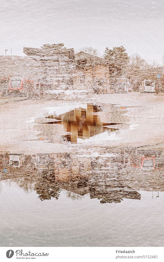 Building reflection in a puddle as double exposure Reflection in the water puddle mirroring Exterior shot Puddle Water Station area Wet Colour photo
