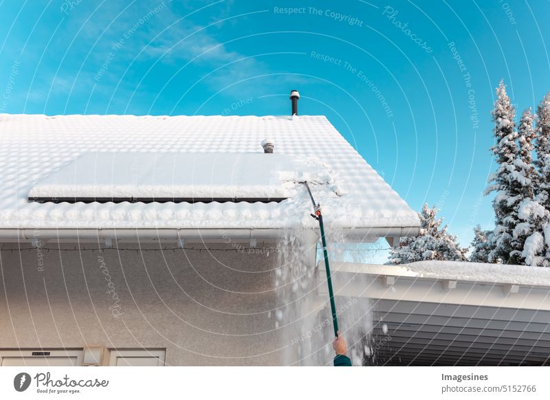 Shoving snow on the roof. Remove snow from solar system - balcony power plant in winter. Sola plant Roof solar collectors Winter Snow take off