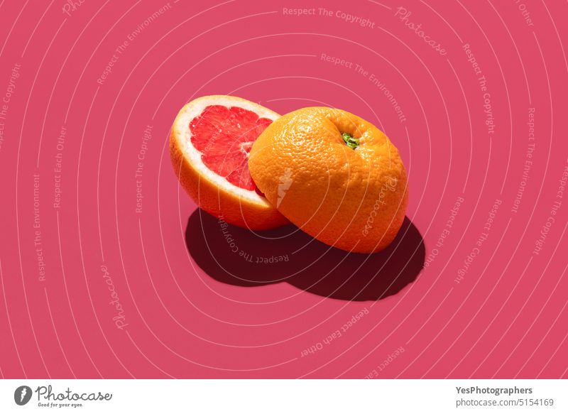 Grapefruit sliced in half, isolated on a magenta background bright citrus close-up color colored copy space cut delicious design dessert food fresh grapefruit