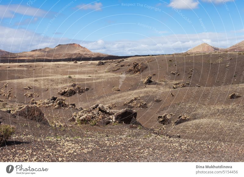 Lanzarote island volcanic landscape with mountains, lava fields and blue sky. Canary Islands horizontal background. Brown beige color palette. natural travel