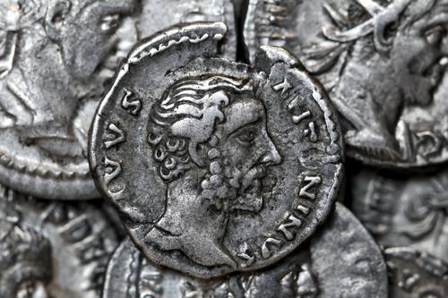 Roman silver denarius coin showing portrait of emperor Antoninus Pius roman ancient money antique finance history economy old empire financial currency treasure