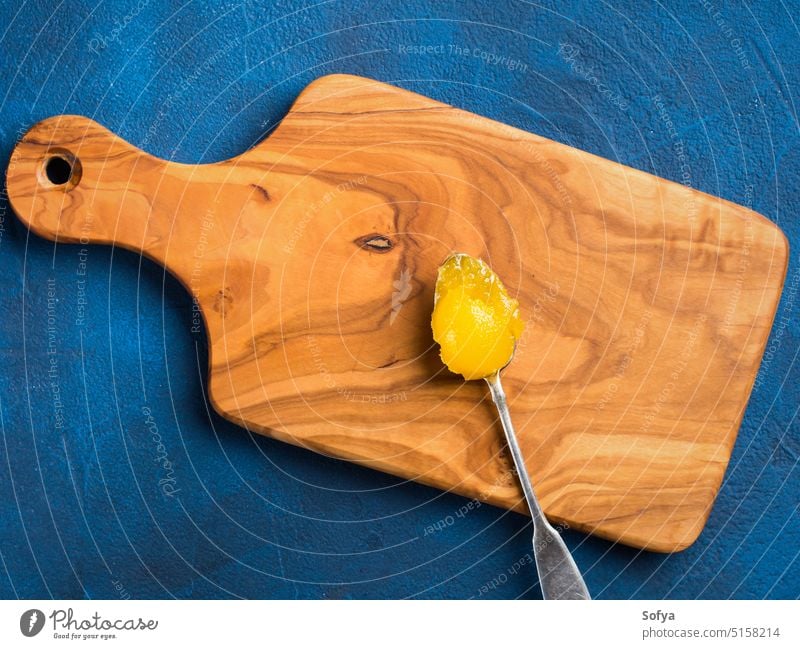 Organic honey on silver spoon organic food sweet sugar eat yellow texture cold cure natural sweetener top view above overhead