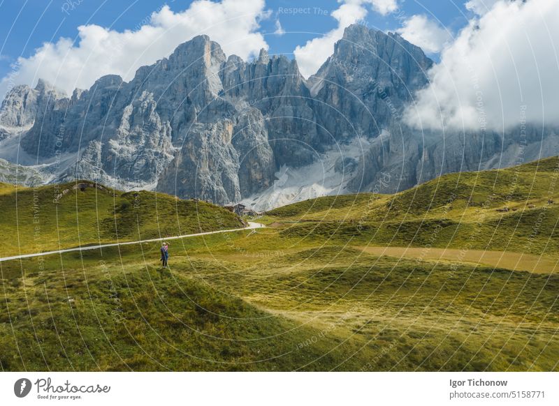 Woman traveler in front of pale di san martino near passo rolle dolomiti, italy, europe aerial woman view scenery nature beautiful alpine mountain landscape