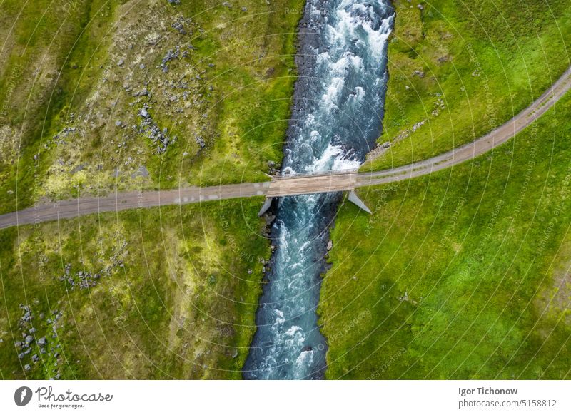 Iceland. Aerial view of road and small bridge over blue mountain river. Aerial scenic view of Iceland landscape. Travel vacation concept iceland aerial travel