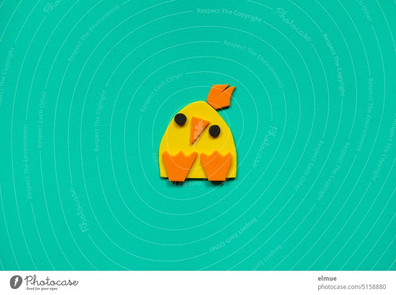 yellow-orange stylized chick made of foam rubber on turquoise background / Easter Chick handicraft Handicraft happy easter Easter decoration Foam rubber