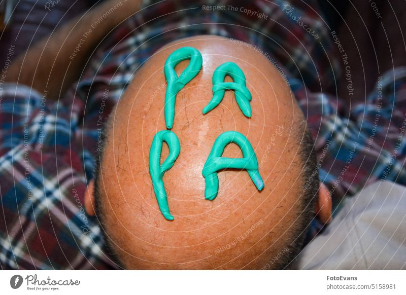 The word PAPA on the head of a bald man shaped writing from above fun. Funny modeling clay human hairless Word Man Head Lifestyle Skin hair loss real