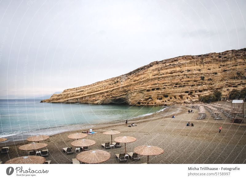 Matala - Beach / Crete Island (Greece) matala hippie caves Mediterranean sea Rock Caves parasols Sun loungers Sand Water Vacation & Travel Tourism coast Ocean