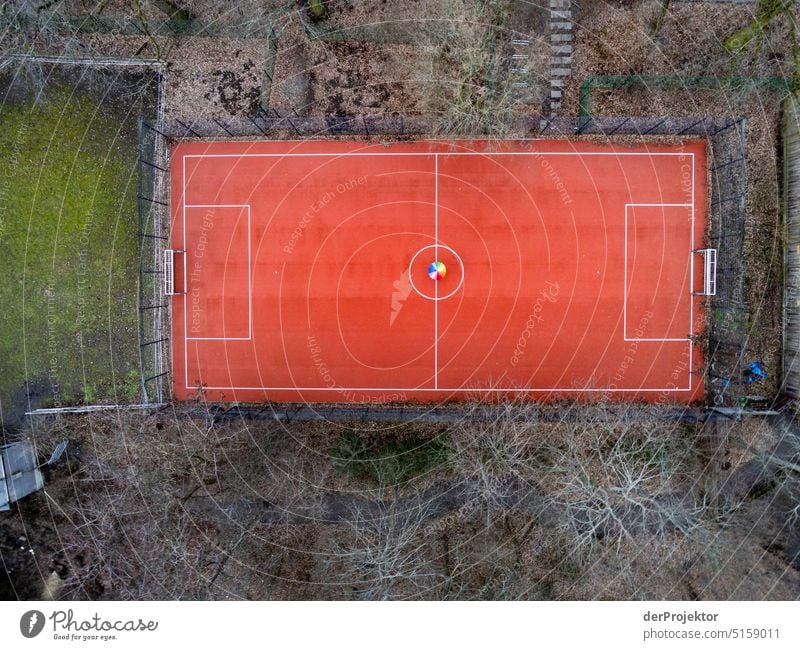 Aerial view of small soccer field with rainbow colored umbrella Sports Aerial photograph Deserted Copy Space middle Structures and shapes Copy Space top Pattern