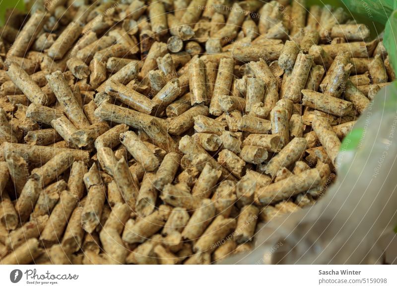 Close up of wood pellets in an opened plastic bag Environment Heap warm Near Close-up detail Detail Material Nature Heating pellets Wood fuel Energy naturally