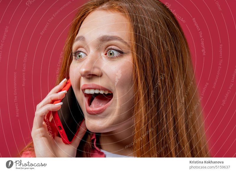 Surprised woman talking by phone, great news, open mouth, wow. Young lady on pink background. Having smartphone call. answering beautiful ask information