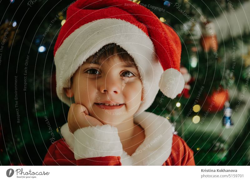 Portrait of adorable boy in Santa Claus costume on Christmas tree background. 4 years old artificial beard baby baby santa celebrate celebration cheerful child