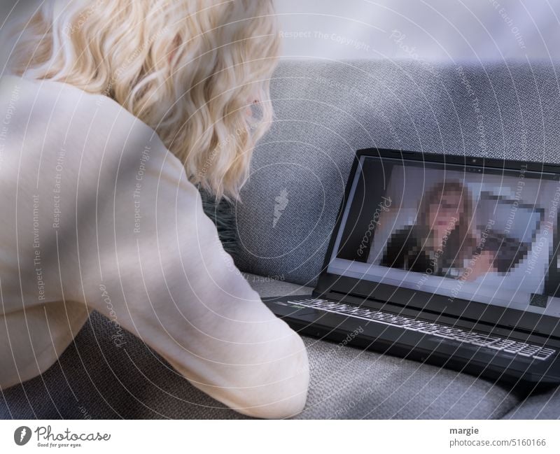 A woman sits in front of a notebook and chats Woman Blonde Notebook Computer Sofa Technology Keyboard Business laptop display Attractive Adults portrait