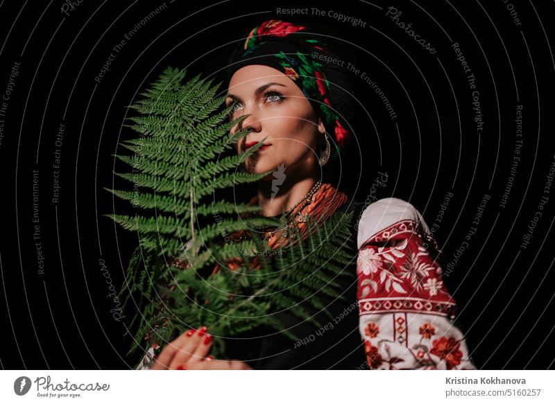 Portrait of ukrainian woman with fern at night in Carpathian mountains forest. attractive beautiful beauty clothes confident costume culture dance dress