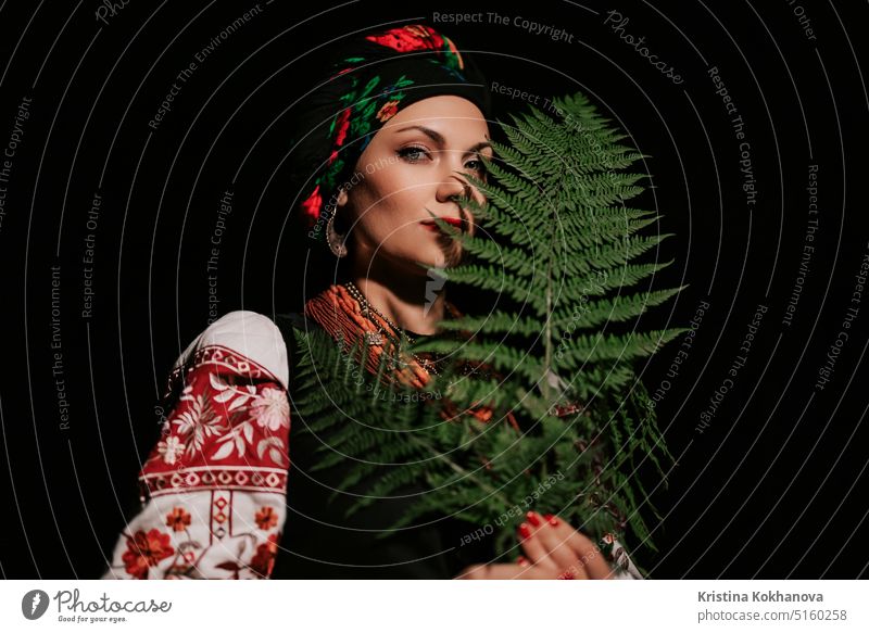Witch woman collects herbs, ferns at night in Carpathian mountains forest. attractive beautiful beauty clothes confident costume culture dance dress