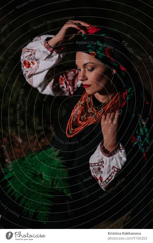 Portrait of ukrainian woman with fern at night in Carpathian mountains forest. attractive beautiful beauty clothes confident costume culture dance dress