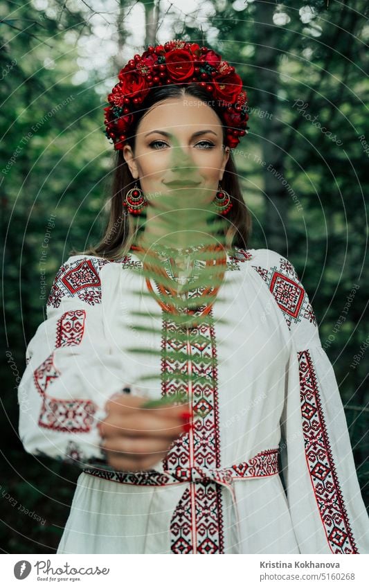 Portrait of ukrainian woman with fern on Carpathian mountains forest background attractive beautiful beauty clothes confident costume culture dance dress