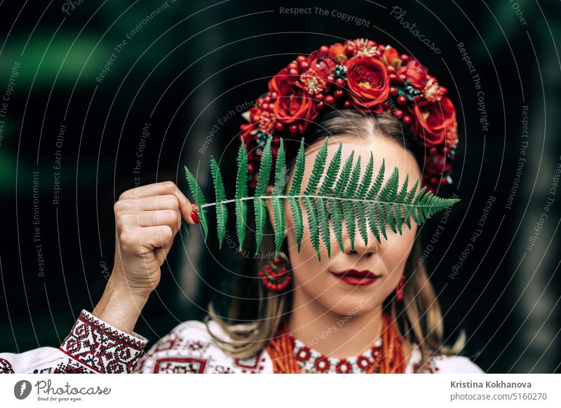 Portrait of ukrainian woman with fern on Carpathian mountains forest background attractive beautiful beauty clothes confident costume culture dance dress