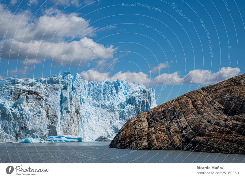 The iceberg and the rock glaciar glacier cold blue patagonia travel nature water ice block big glacier global warming environment landscape
