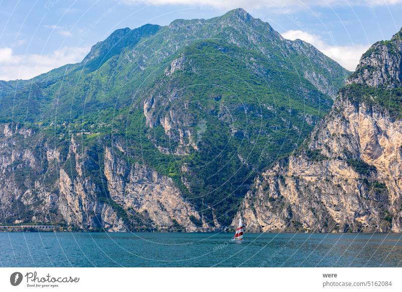 Wooded mountain top and rock wall on the northern shore of Lake Garda in Italy Mediterranean Rock wall alps climbing copy space italian italy lake landscape