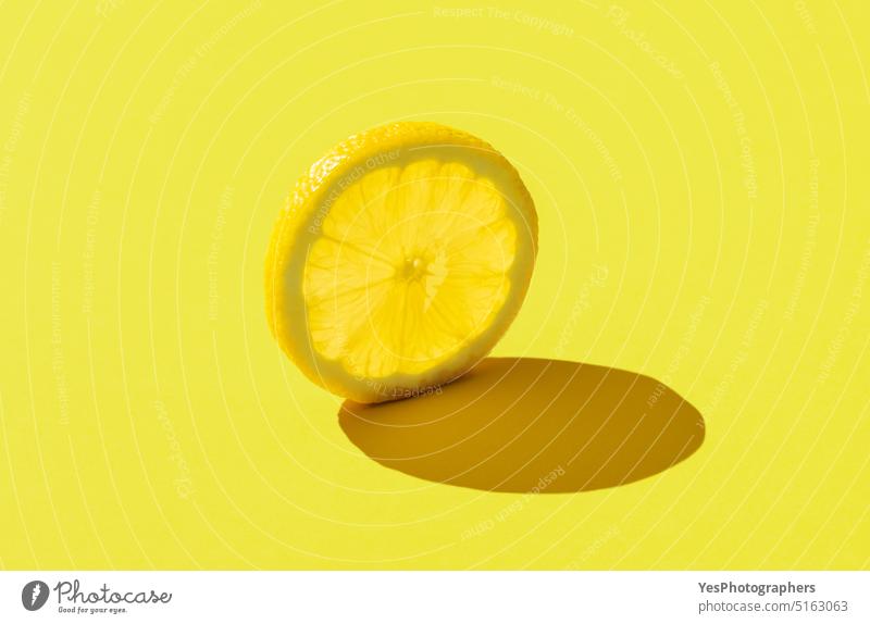 Lemon slice minimalist on a yellow background abstract bright citrus close-up color colorful concept copy space creative cuisine cut out delicious design diet