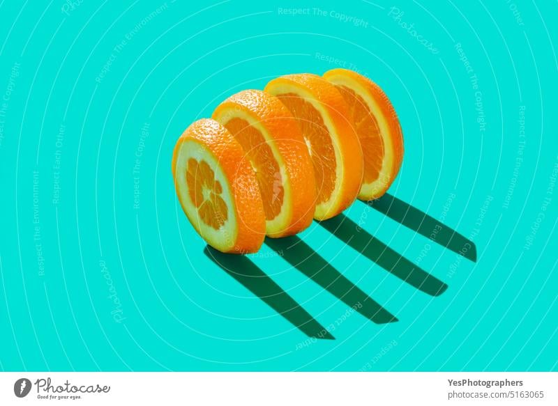 Sliced orange isolated on a blue cyan background abstract bright citrus close-up color colorful concept copy space creative cuisine cut out delicious design