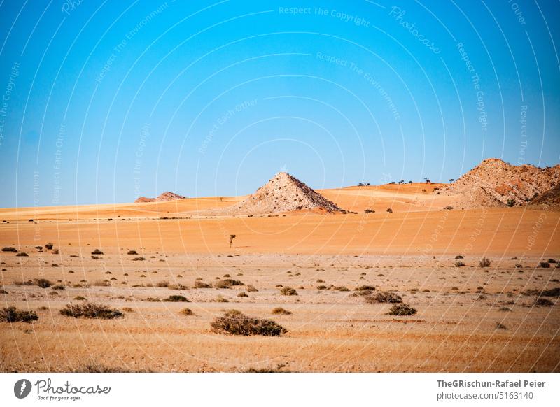 Pyramid shaped hill in desert against blue sky Namibia Mountain travel Landscape Nature Rock Vacation & Travel Africa Exterior shot Far-off places Deserted Sky