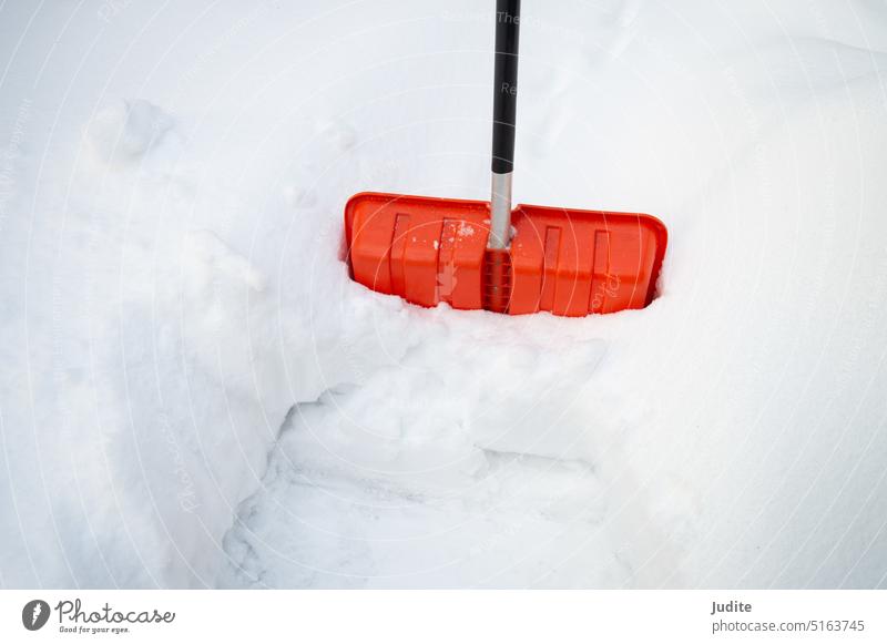 Red plastic snow shovel with black handle blizzard clean clear cold concept day deep dig driveway equipment exercise frost frozen gardening ice job labor