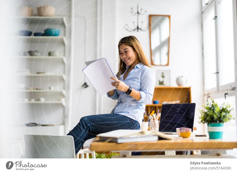 Young female freelancer working in loft office real people millennials student indoors window natural girl adult one attractive successful confident person