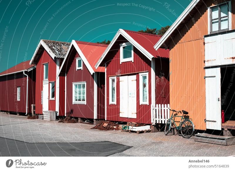 Colorful traditional fisherman huts, boathouses in row small harbor. Storage for fishing or rented as Holiday cottage summer water faaborg fishermans