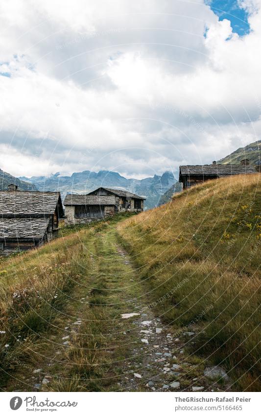 Road in front of alps with stone roofs in Switzerland Vals Alps stone house valser stone Mountain Stone Exterior shot House (Residential Structure) Day Deserted