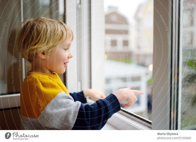 A child of primary school age is at risk of falling from a window from a great height falling out unlocked open kid little preschooler windowsill home unsafe