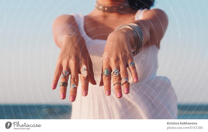 Beautiful gypsy woman dancing hands with boho jewelry. Girl in white dress girl young beauty summer attractive bracelets fashion style tan tropical beautiful
