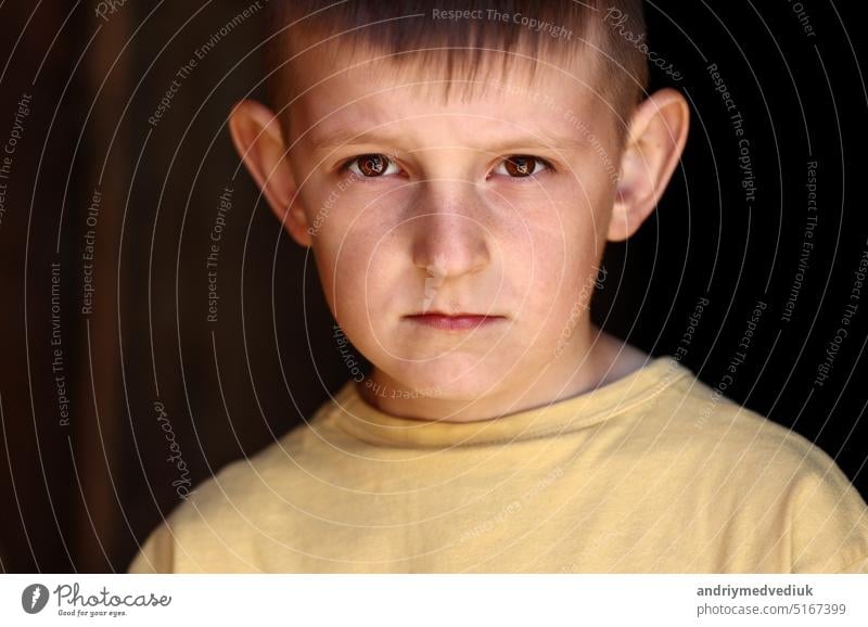 close up portrait of little child. kid boy outdoors looking in camera. Face Eyes Serious Contemplative Child. looking at camera beautiful childhood caucasian