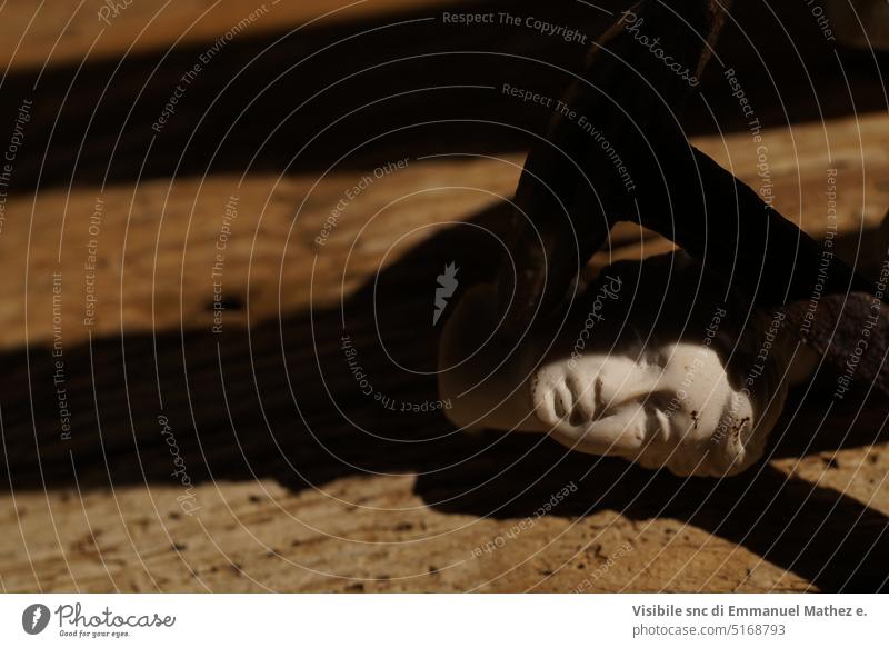 woman head statue laying on wooden table in the shadow venus violence concept woman rights antique roman greek ancient battle blind fury rape