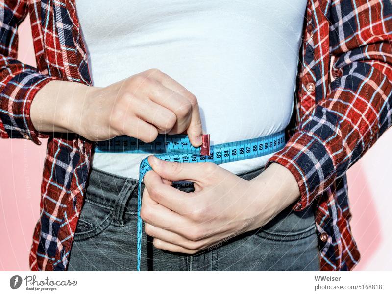 A girl, worried about her figure, measures the circumference of her waist with a tape measure Measure Tape measure Scope Waist Slim Thin slimming craze Girl
