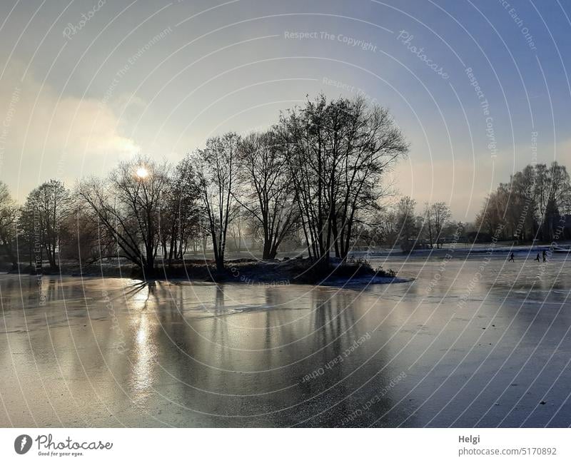 ice cold sunny winter atmosphere at frozen lake, in the background very tiny three ice skaters Winter Winter mood Lake chill Ice Frozen surface Sunlight Light