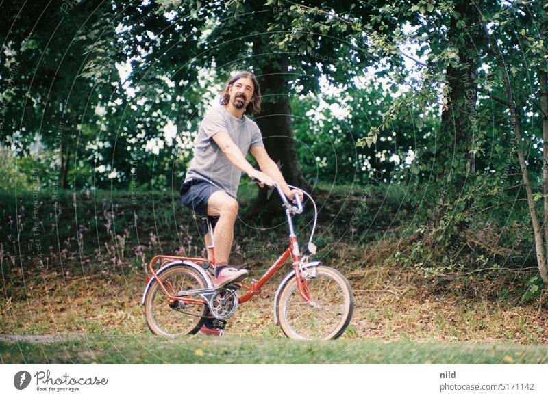 Klappi! Folding bicycle Bicycle Cycling Nonsense get up to mischief Comical person Colour photo fool around people fun Jokes color photograph Retro vintage