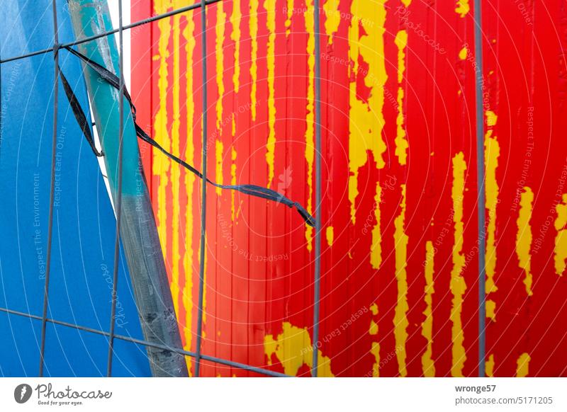 motley(e) | construction site topic day Construction site Container Hoarding lattice fence Old flaking paint red and yellow cordon Safety Metalware Close-up