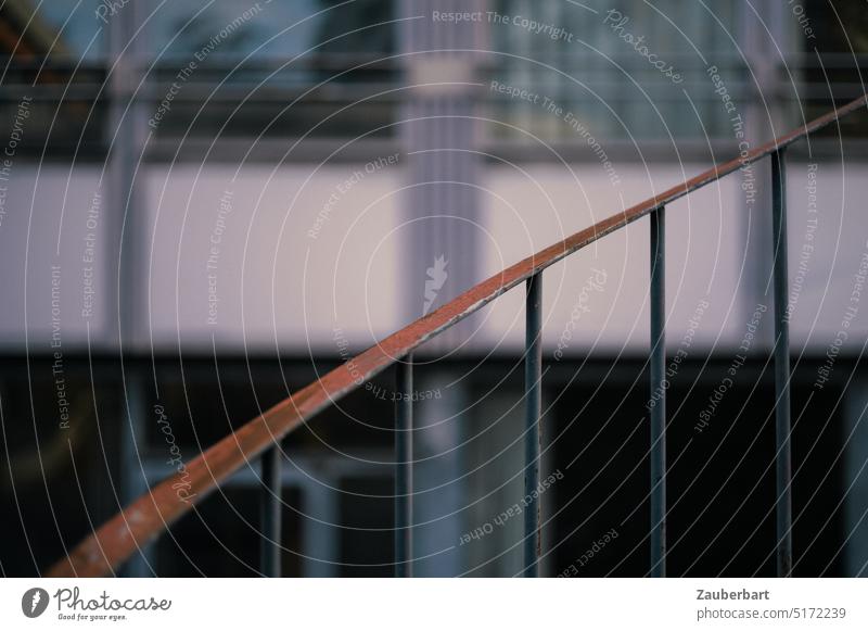 Balustrade of spiral staircase with handrail made of thin steel, swings upwards in front of modern facade Stairs Winding staircase Swing Upswing Downturn