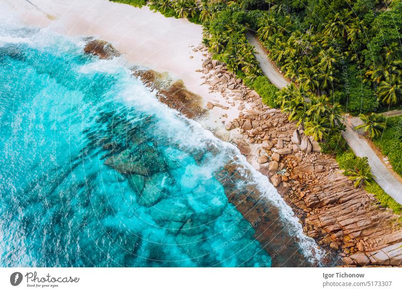 Aerial photo of ocean waves hitting rocky coastline of beautiful paradise dream tropical beach at Seychelles. Summer vacation, travel and lifestyle concept