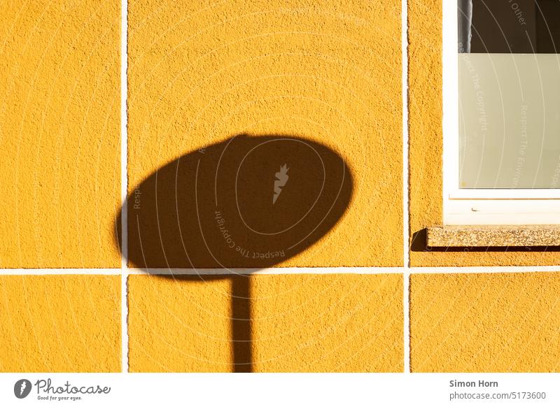 Shadow of a traffic sign house wall Yellow sunshine warm urban Summer Spring Road sign Bright Structures and shapes geometric town planning Traffic planning