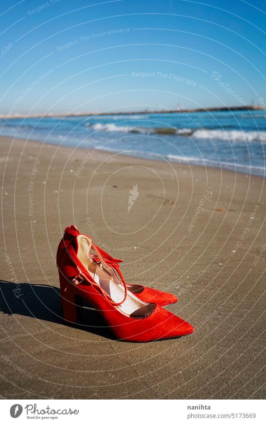 Red high heels  with retro style abandoned in a seashore near the sea freedom fashion missing shoes woman thriller alone run away left over vintage mystery flee