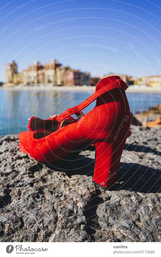 Touristical image of red high heels in a cliff with Alboraya, Valencia, as  background travel mediterranean summer holidays tourism sea coast shoes woman lost