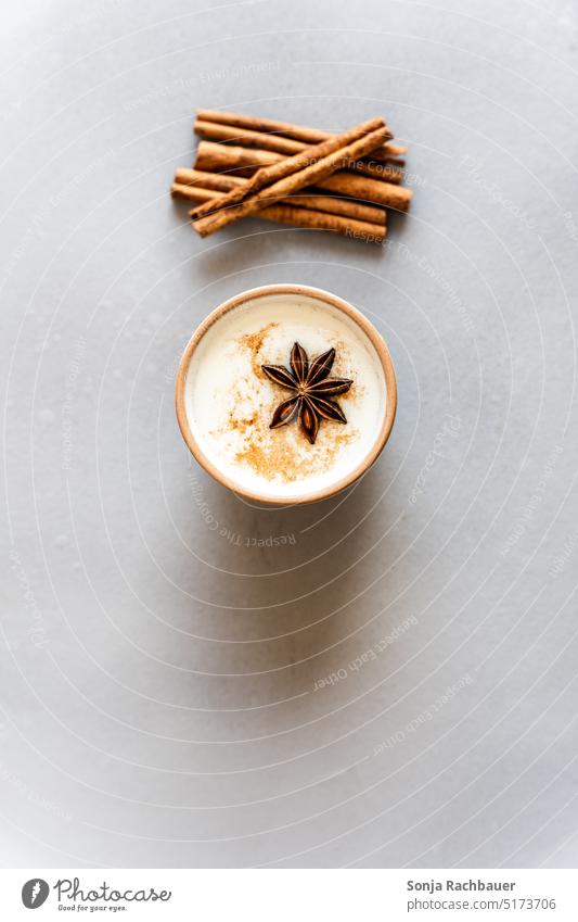 A cup of chai latte on a gray table. Top view. Chailatte Black tea spices Hot drink India Beverage Cup milk foam Colour photo Bird's-eye view Tea Table Gray