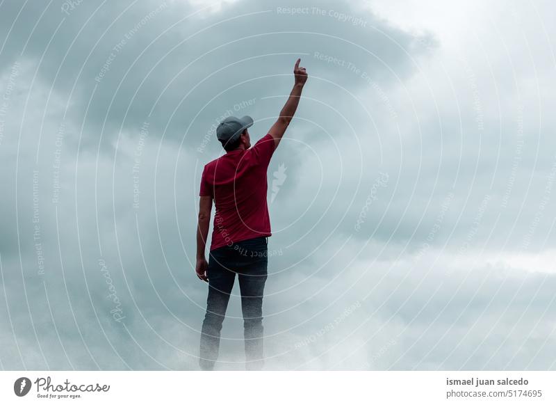 man portrait gesturing in the sky and clouds person one person nature landscape fog view feeling free traveling trekking hiking standing adventure outdoors